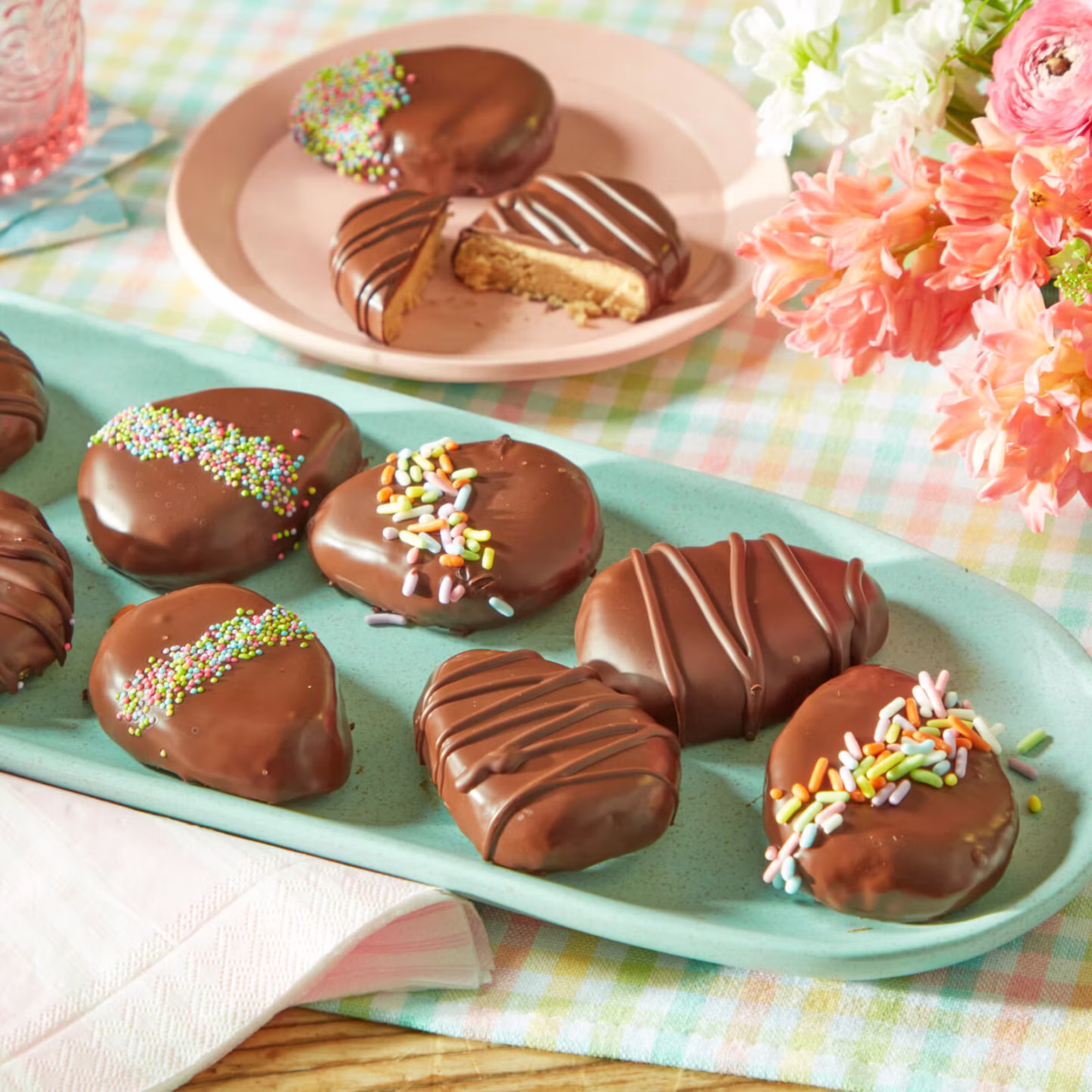 homemade peanut butter Easter eggs with chocolate coating styled on a neutral Easter dessert table